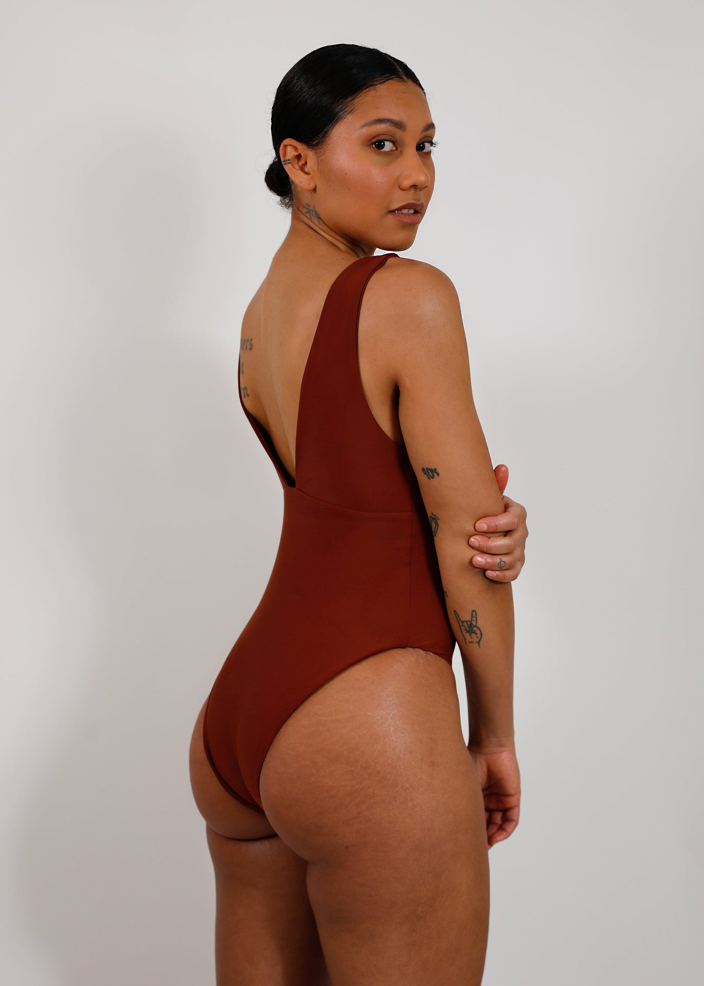 model with brown sustainable v-neck one piece