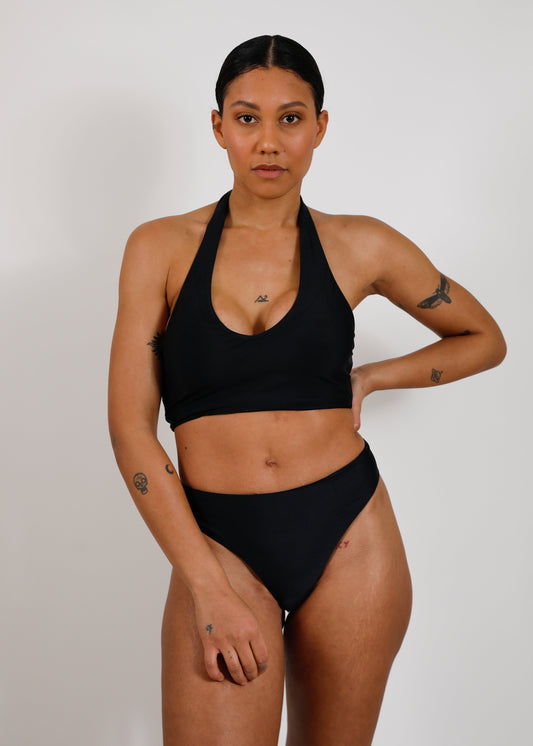 model with sustainable black tieback bikini top