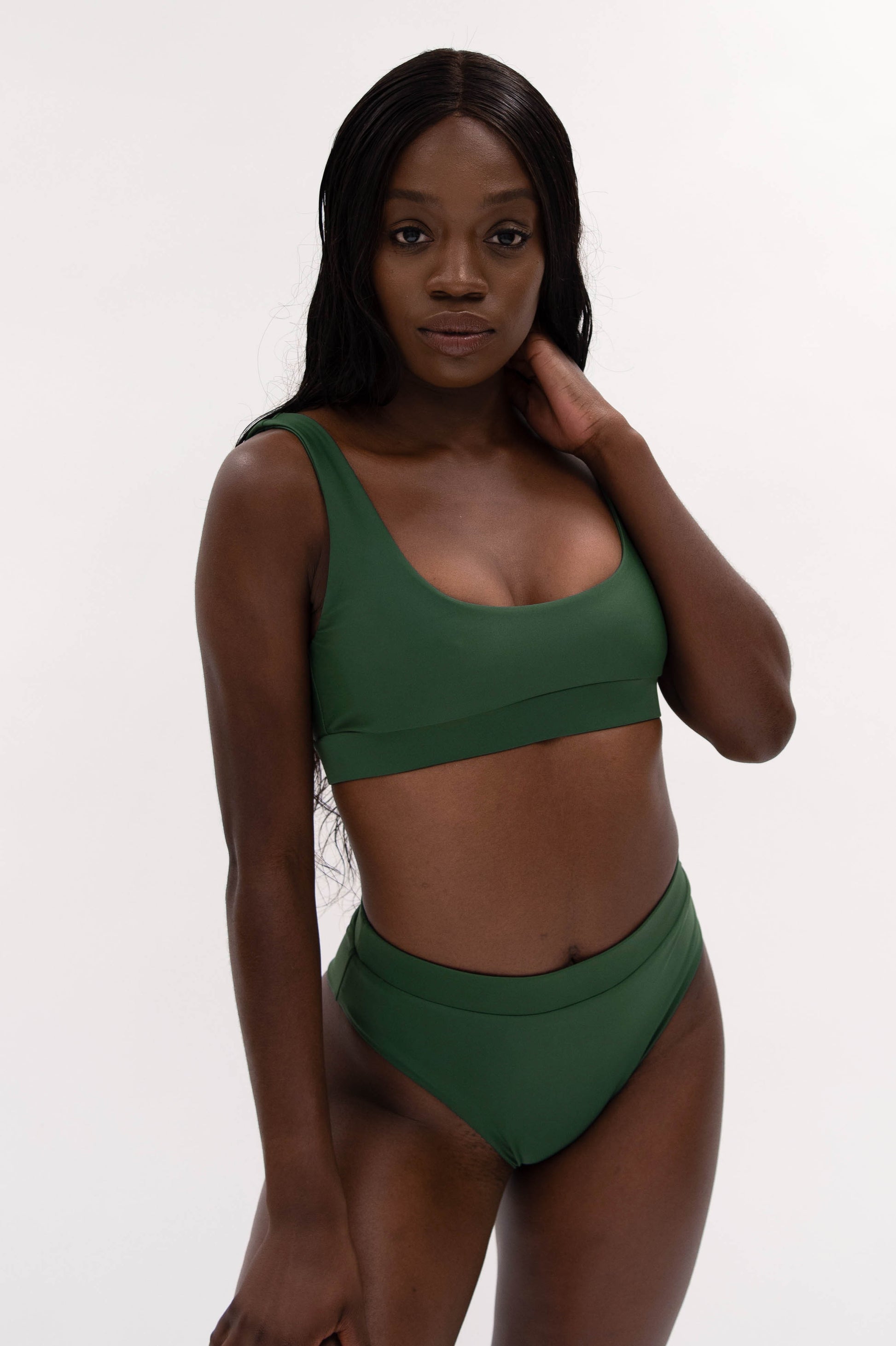 model with green sustainable high cut bikini bottom and sporty top 