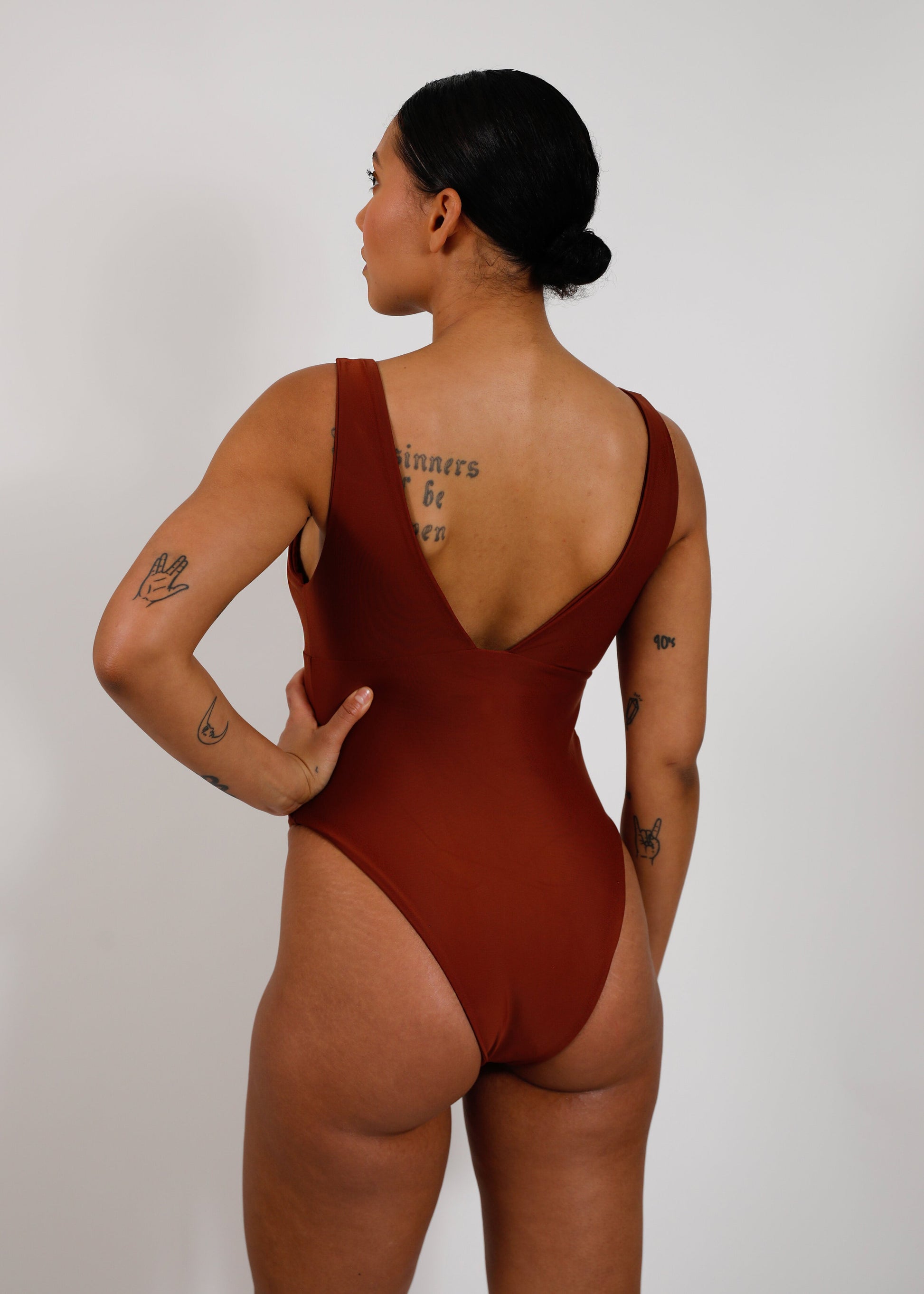 model with brown sustainable v-neck one piece 