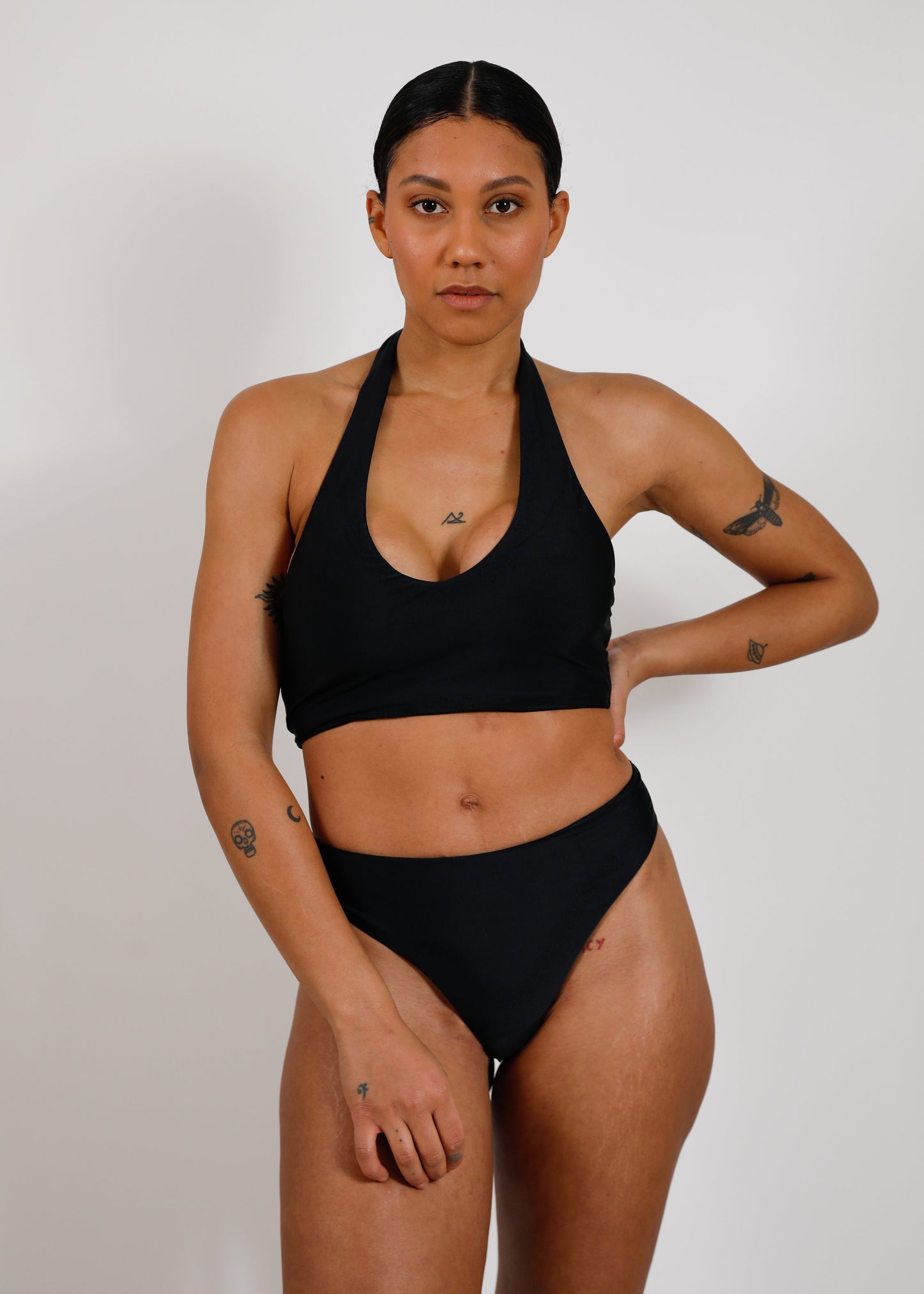 model with sustainable black bikini bottom